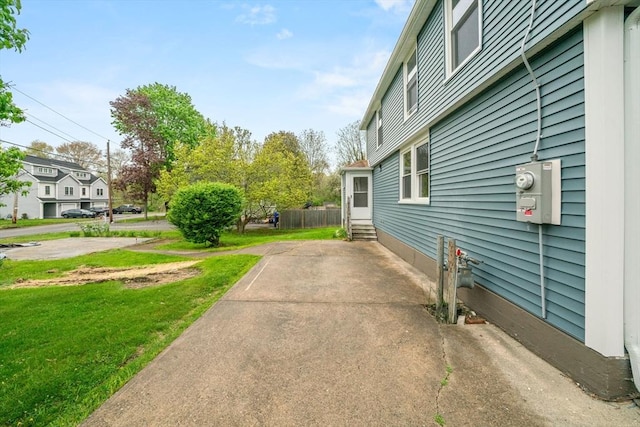 view of side of property with a yard