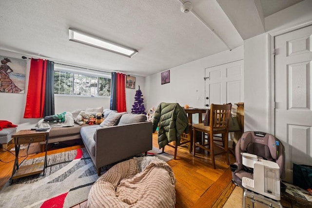 living room featuring wood finished floors and a textured ceiling