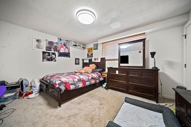 bedroom featuring light carpet and a textured ceiling