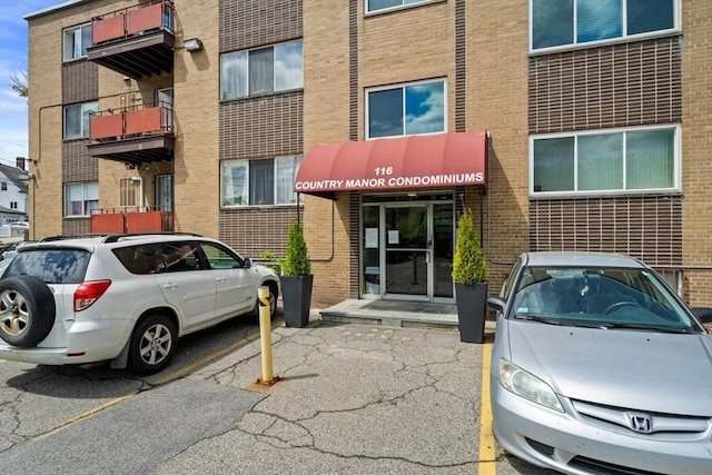 view of property featuring uncovered parking