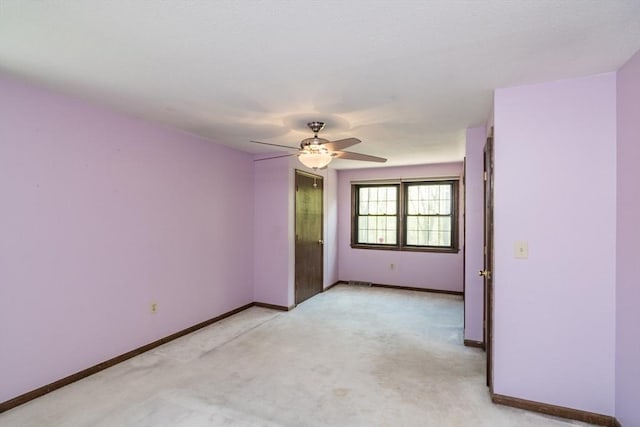 unfurnished room with baseboards, light carpet, visible vents, and ceiling fan