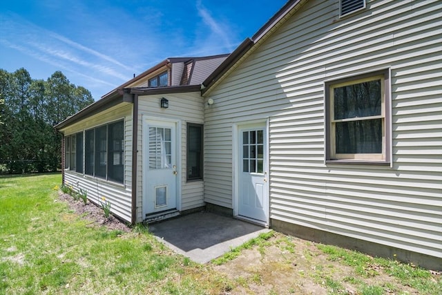 back of house featuring a lawn and a patio