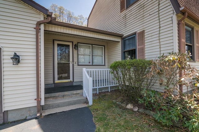 view of exterior entry featuring covered porch
