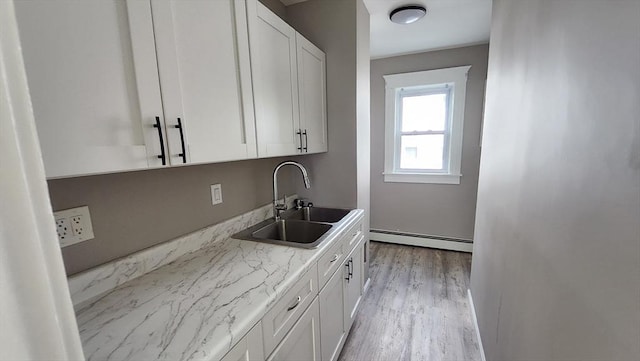 97-99 Blaisdell St Unit 2, Haverhill, MA 01832 - kitchen with baseboard heating, white cabinets, and wood finished floors
