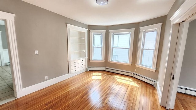 97-99 Blaisdell St Unit 2, Haverhill, MA 01832 - spare room with light wood-style floors and a baseboard heating unit