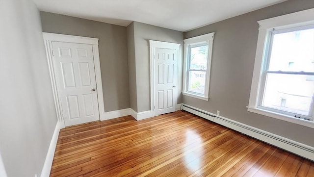 97-99 Blaisdell St Unit 2, Haverhill, MA 01832 - unfurnished bedroom with baseboard heating, light wood-style floors, and a closet
