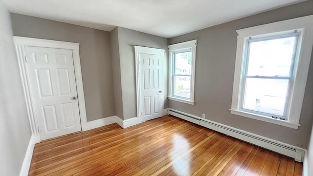 97-99 Blaisdell St Unit 2, Haverhill, MA 01832 - unfurnished bedroom with a baseboard heating unit, light wood-type flooring, and a closet