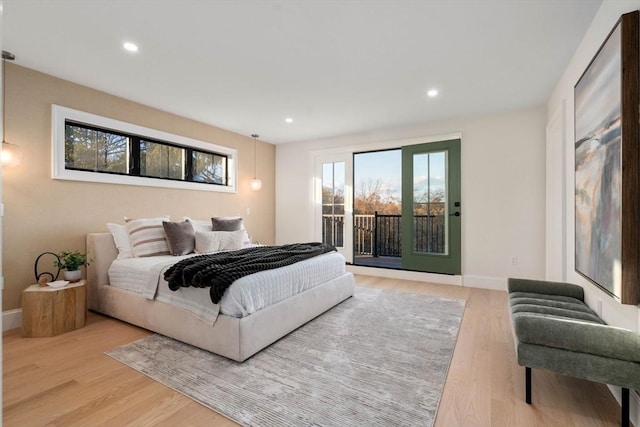 bedroom featuring light hardwood / wood-style floors and access to exterior