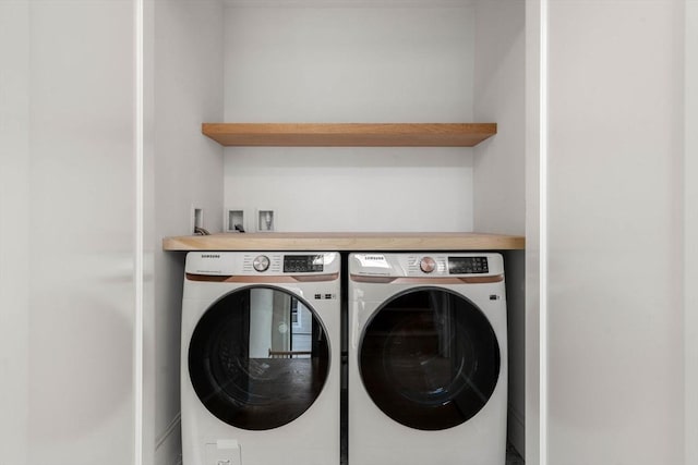 washroom with washer and dryer