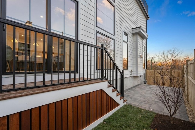 property exterior at dusk featuring a patio