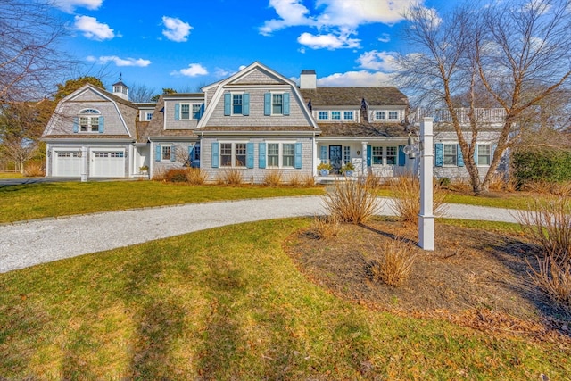 view of front of home with a garage and a front lawn