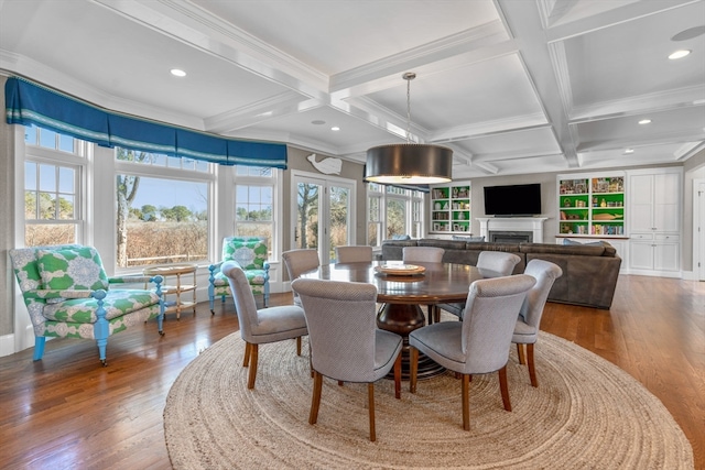 dining space featuring coffered ceiling, hardwood / wood-style flooring, and crown molding