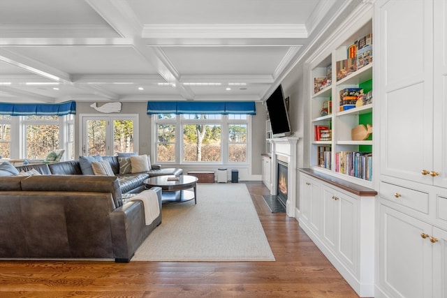 living room with beam ceiling, crown molding, french doors, coffered ceiling, and hardwood / wood-style flooring