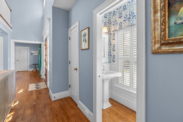 hall featuring hardwood / wood-style flooring and a healthy amount of sunlight