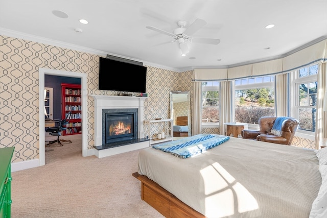 carpeted bedroom with ornamental molding and ceiling fan