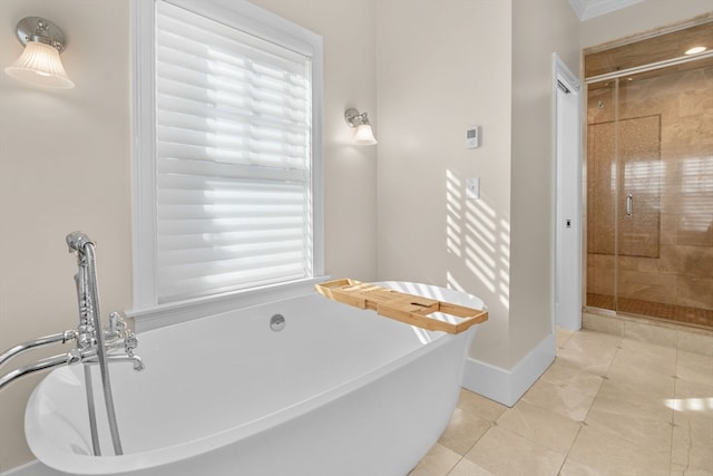 bathroom with plus walk in shower, a healthy amount of sunlight, and tile patterned flooring