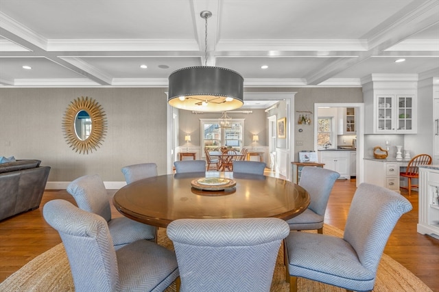 dining room featuring ornamental molding, dark hardwood / wood-style flooring, and coffered ceiling