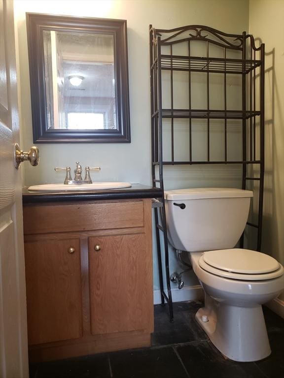 bathroom featuring toilet, vanity, and tile patterned floors