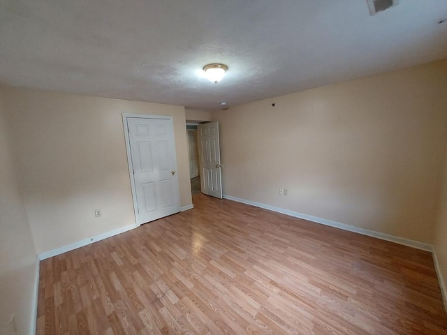 spare room featuring light hardwood / wood-style flooring