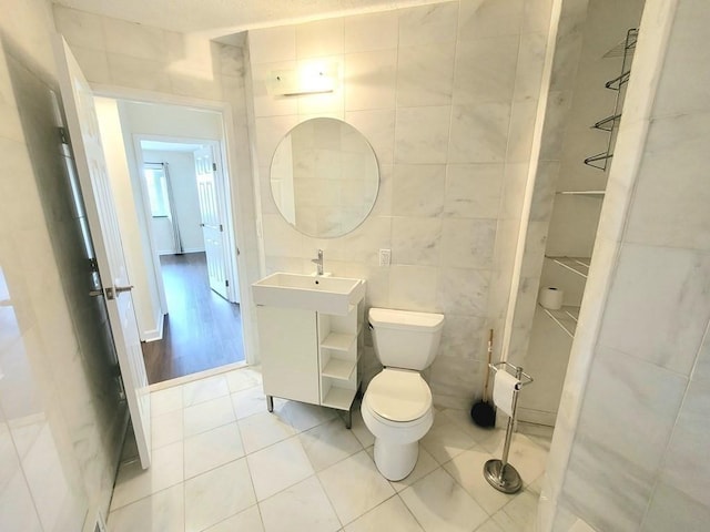 90 Quincy Shore Dr Unit 303, Quincy, MA 02171 - bathroom with tile walls, tile patterned flooring, and vanity
