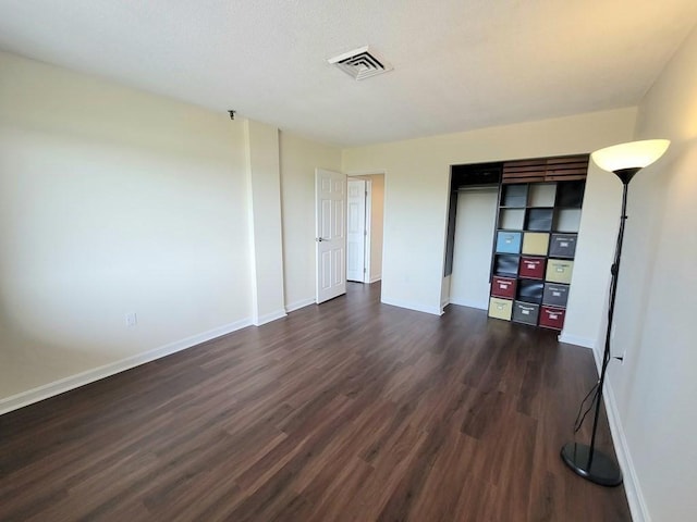 90 Quincy Shore Dr Unit 303, Quincy, MA 02171 - unfurnished bedroom featuring dark wood finished floors and a closet
