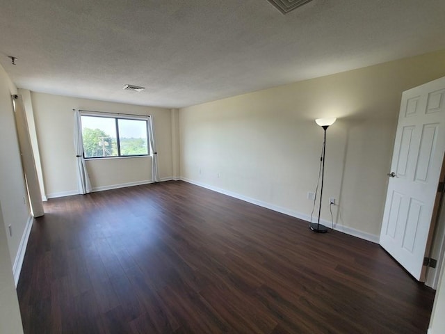 90 Quincy Shore Dr Unit 303, Quincy, MA 02171 - unfurnished room with dark wood finished floors and a textured ceiling
