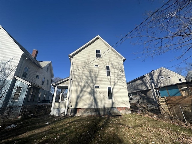 rear view of house with a yard