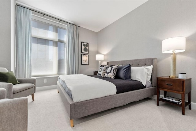 bedroom with light carpet and baseboards