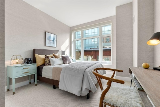 bedroom with light carpet and baseboards