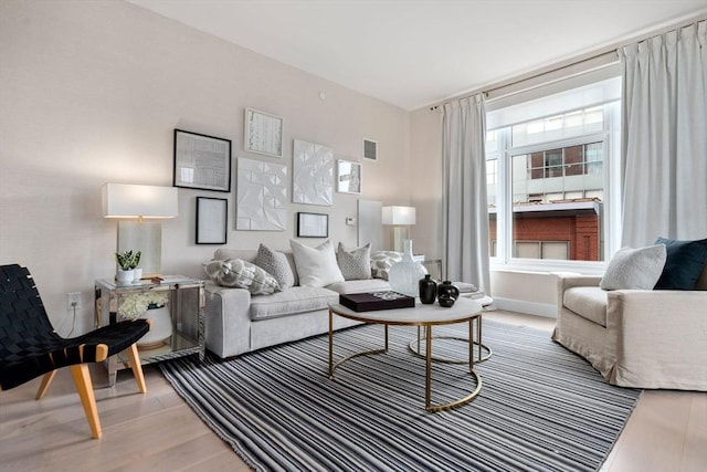 living room with light wood-type flooring and visible vents