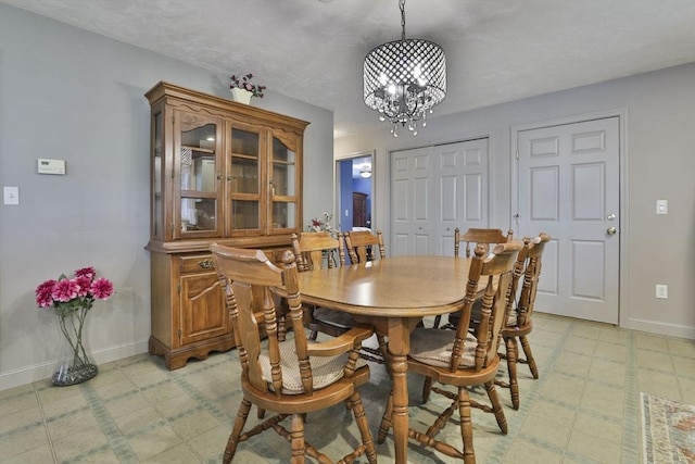 219-221 Wilson St Unit 1, Haverhill, MA 01832 - dining area with light flooring, baseboards, and a chandelier