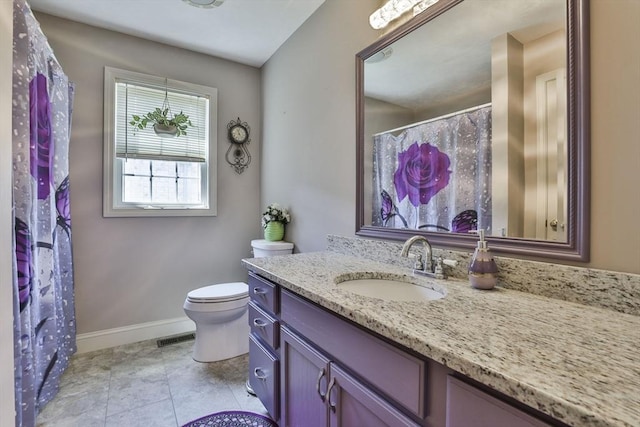 219-221 Wilson St Unit 1, Haverhill, MA 01832 - bathroom featuring vanity, toilet, and baseboards