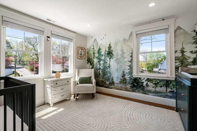 interior space with baseboards, visible vents, and multiple windows