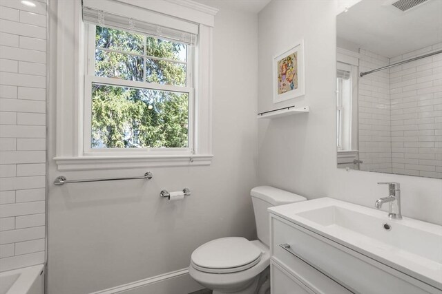 bathroom featuring vanity, tub / shower combination, visible vents, and toilet
