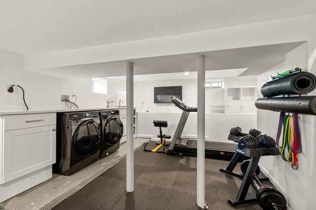 exercise area featuring separate washer and dryer and light carpet