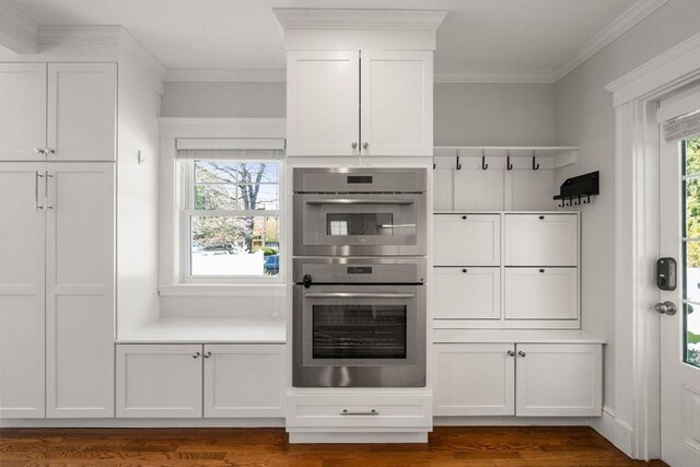 mudroom featuring ornamental molding and dark wood-style floors