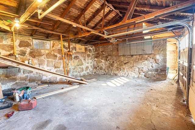 miscellaneous room with lofted ceiling and concrete flooring