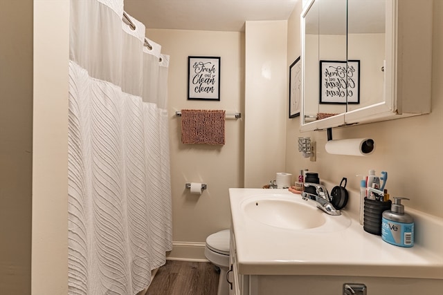 bathroom with vanity, toilet, wood-type flooring, and walk in shower