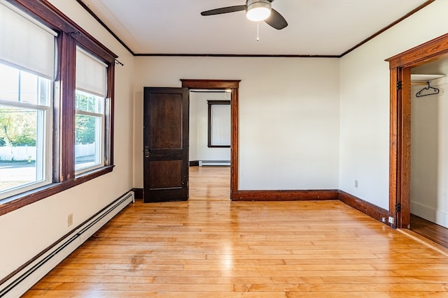 unfurnished bedroom featuring light hardwood / wood-style floors, a baseboard radiator, and ceiling fan