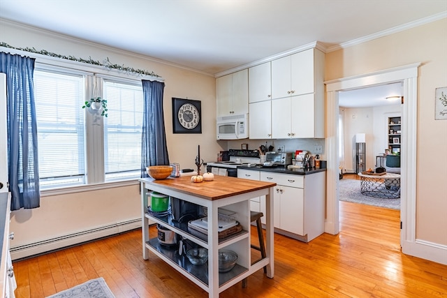 kitchen featuring white appliances, light hardwood / wood-style flooring, baseboard heating, and white cabinets