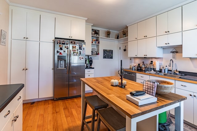 kitchen featuring white cabinets, stainless steel appliances, and light hardwood / wood-style floors