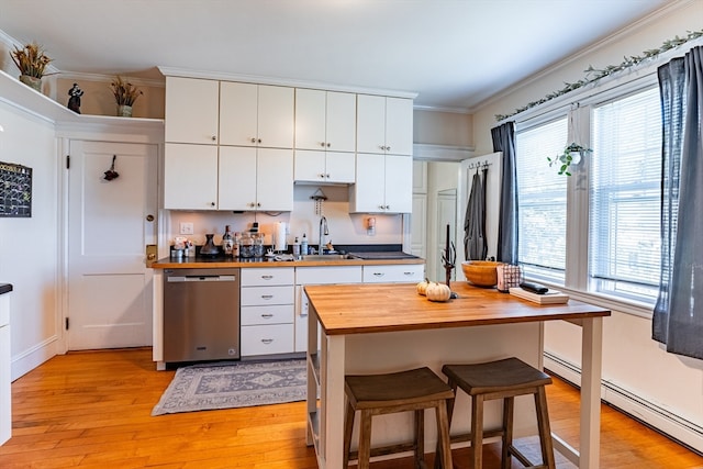 kitchen with white cabinetry, dishwasher, butcher block counters, and a healthy amount of sunlight