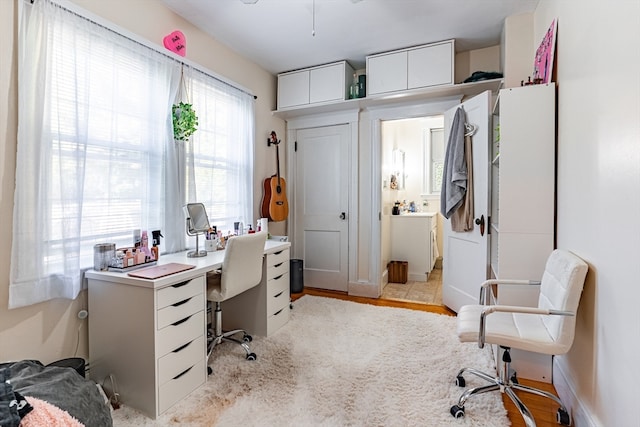 home office with light hardwood / wood-style floors