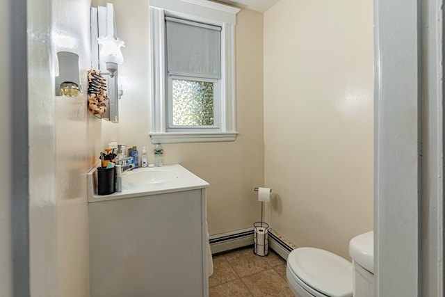 bathroom featuring baseboard heating, vanity, toilet, and tile patterned floors