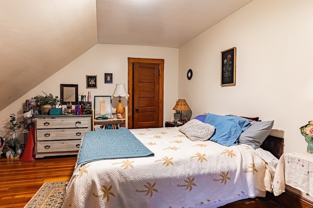 bedroom with dark wood-type flooring and vaulted ceiling