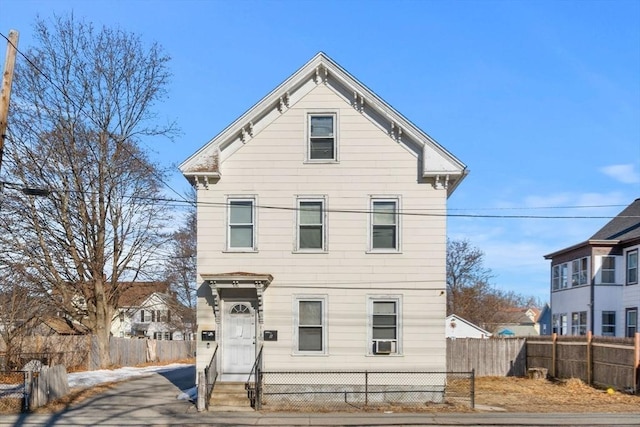 view of front of house with a fenced front yard and cooling unit