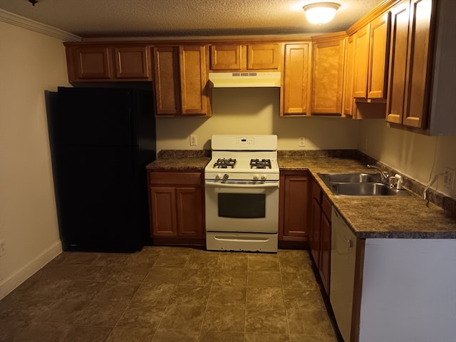 kitchen with crown molding, a textured ceiling, white appliances, sink, and dark tile floors