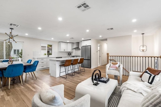 26 Parsons Dr, Swampscott, MA 01907 - living room with a chandelier, light wood-type flooring, and recessed lighting
