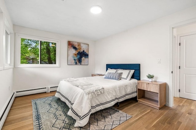 26 Parsons Dr, Swampscott, MA 01907 - bedroom featuring wood finished floors, a baseboard heating unit, and baseboards