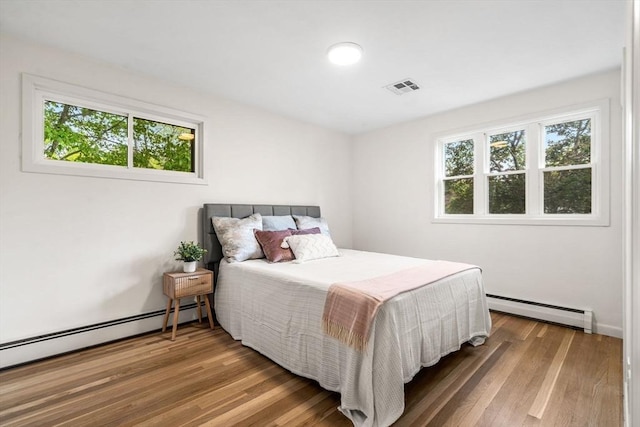26 Parsons Dr, Swampscott, MA 01907 - bedroom with baseboard heating, multiple windows, a baseboard heating unit, and wood finished floors